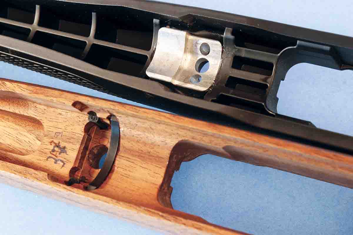 The forends of injection molded stocks are often stiffened by cross walls like those on this stock (top) from a Sauer 101, which also features a bedding block. The walnut stock is from a Mauser Model 12 and uses a small steel bedding block.